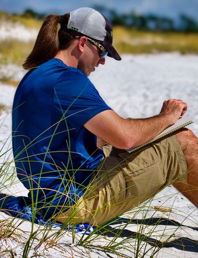 Caleb sitting on beach